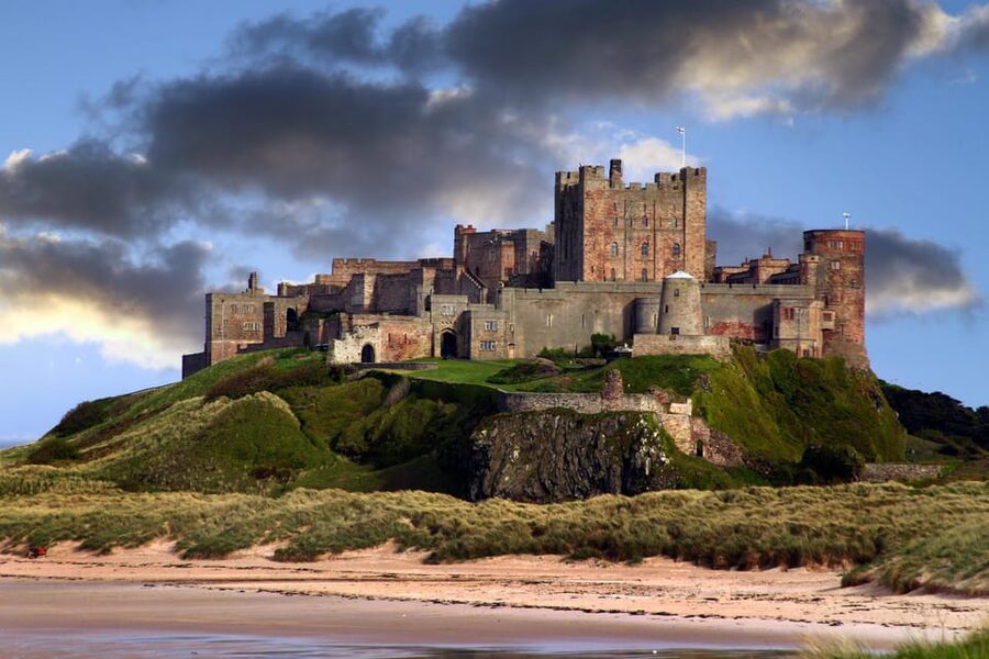 Edinburgh: Bamburgh Castle, Northumberland and Alnwick Trip - Bamburgh Castle above the coast